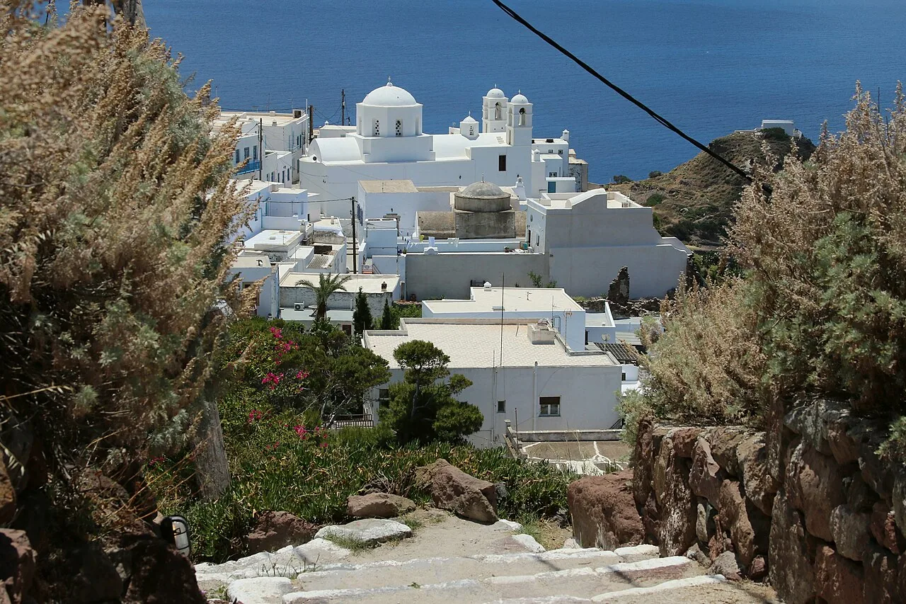 Plaka: white houses and a church on the hill above the sea